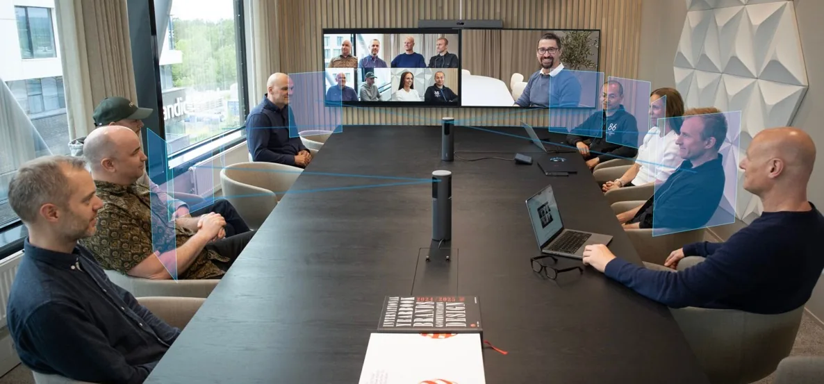 Team on a video call using a Neat Bar in an enterprise boardroom, deployed and supported by Capstar Solutions
